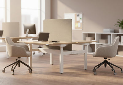 Aarhus Contour Task Chairs positioned at desks in a modern office interior, featuring two ergonomic chairs set against beige walls with wooden flooring, tall ceilings and large windows, highlighting contemporary task seating for professional workspaces.