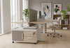 Moda Mobile Storage Cabinet in a modern office interior with oak flooring, beige walls and tall windows, showcasing its compact two-drawer one-door design, fabric-upholstered door panel and mobile caster base; contemporary office storage solution for flexible, space-efficient workspace organisation.
